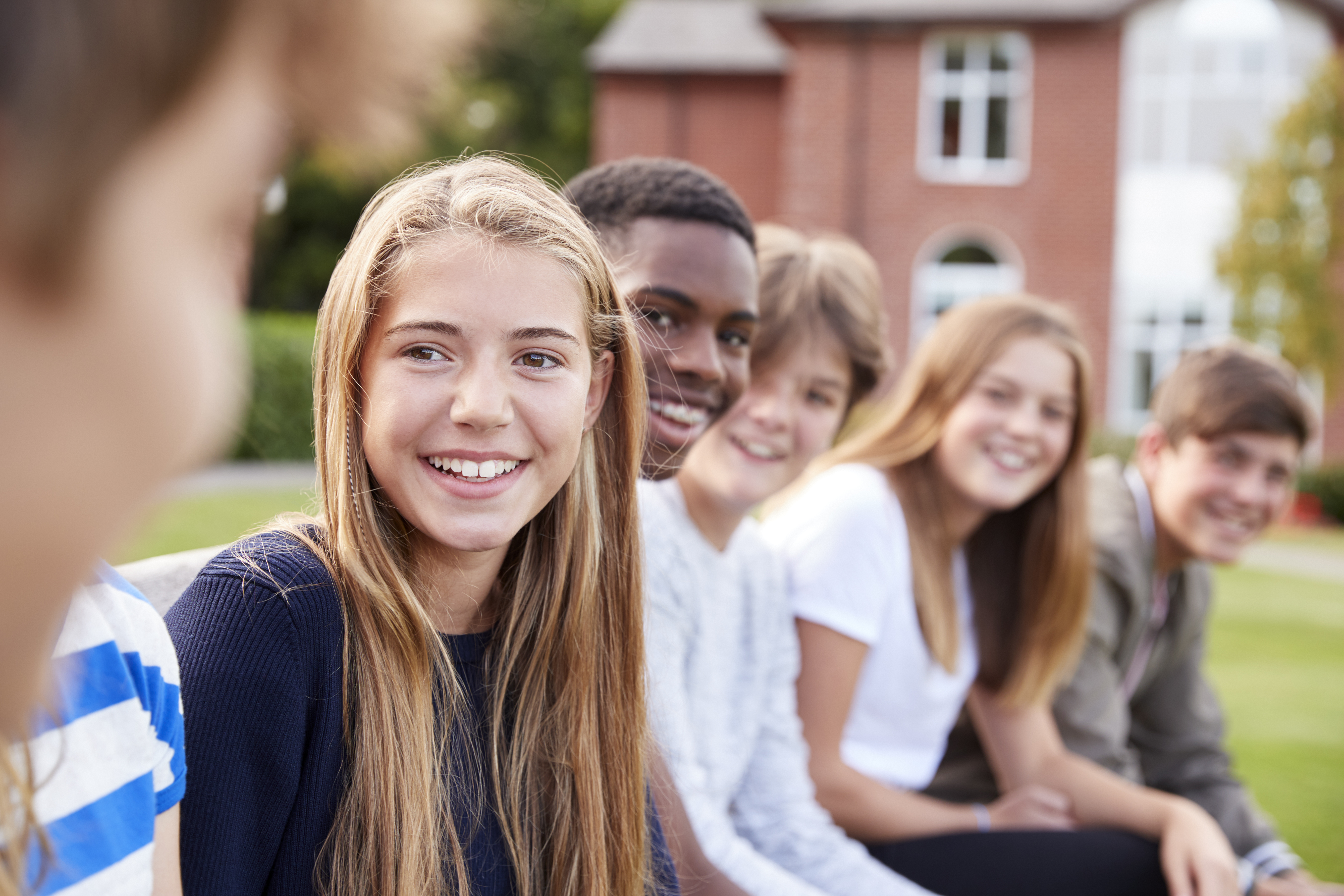 teenagers sitting outside