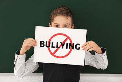 Tween boy holding a Stop Bullying sign