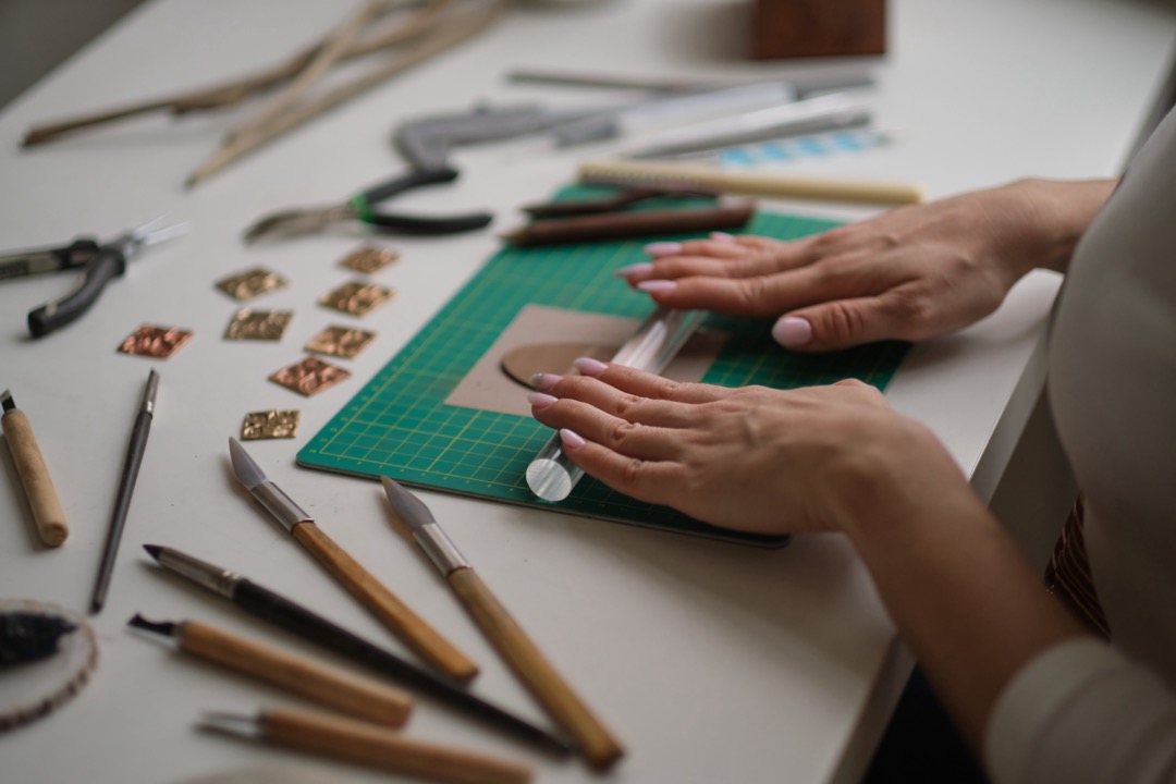 A woman crafting supplies on a table