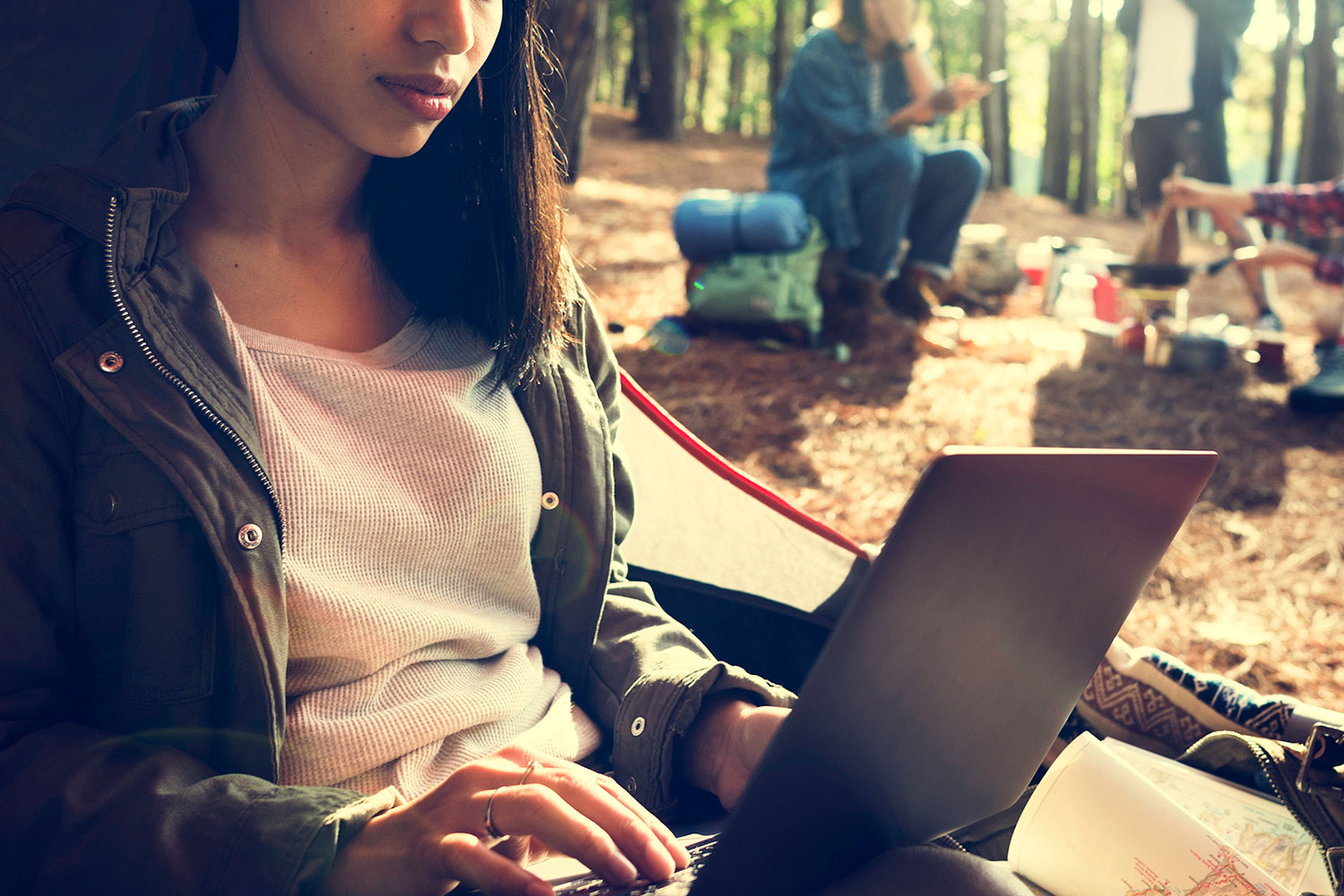 woman using a laptop while camping