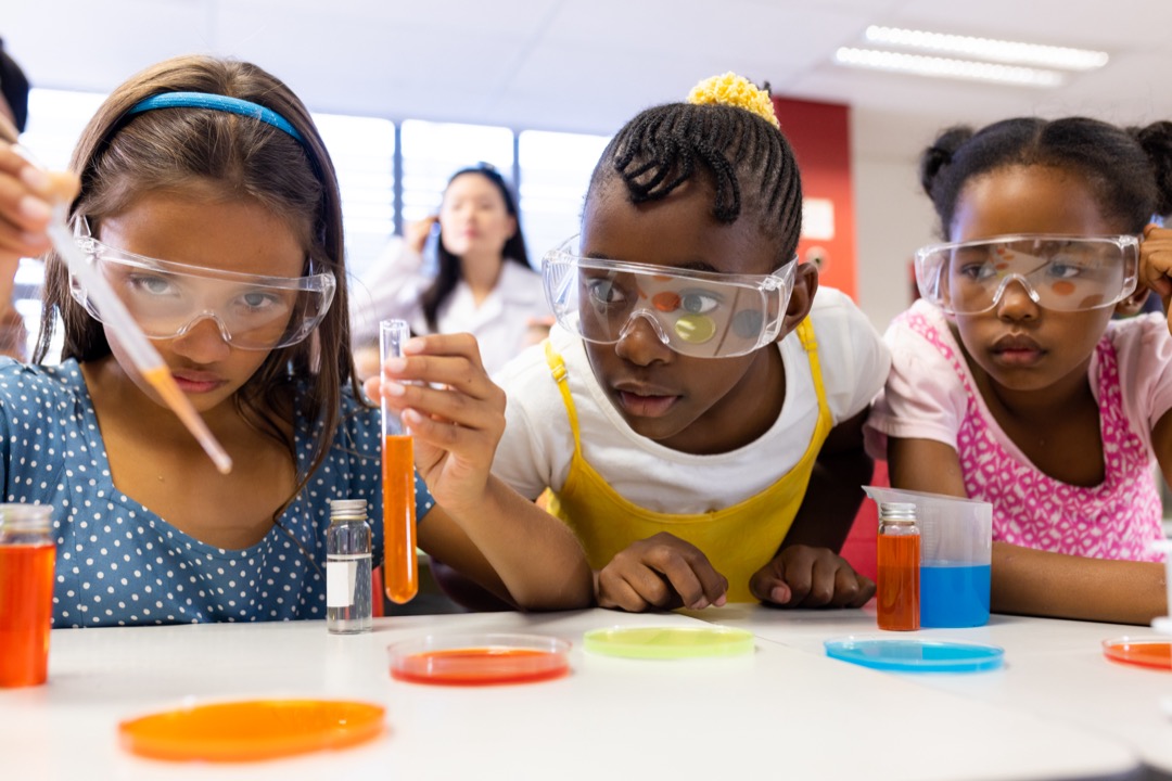 Kids doing a science test within a classroom