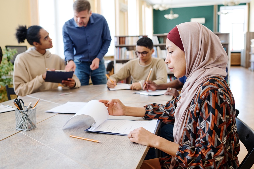 Woman looking at notes during a clas