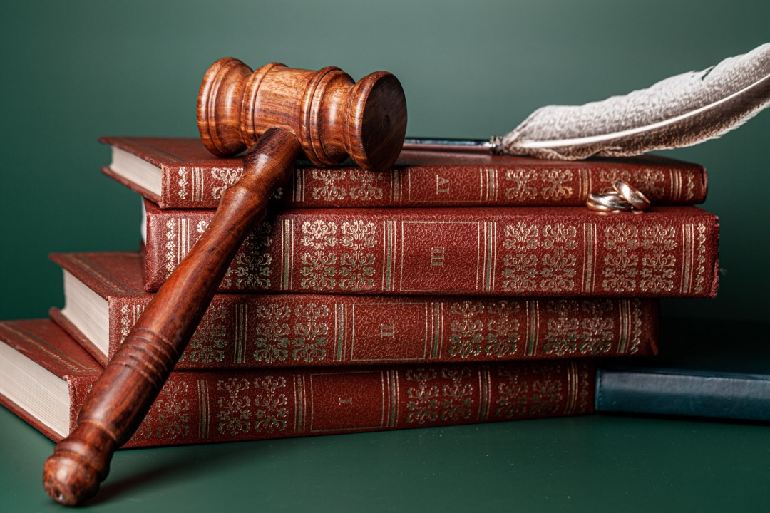 A stack of Law books with a gavel on top