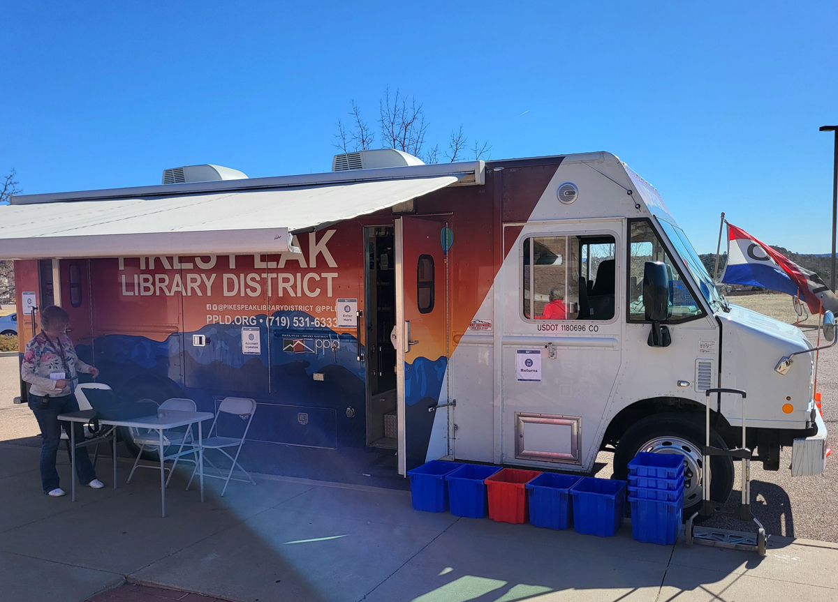 Mobile Library Parked on the side of a street with an awning