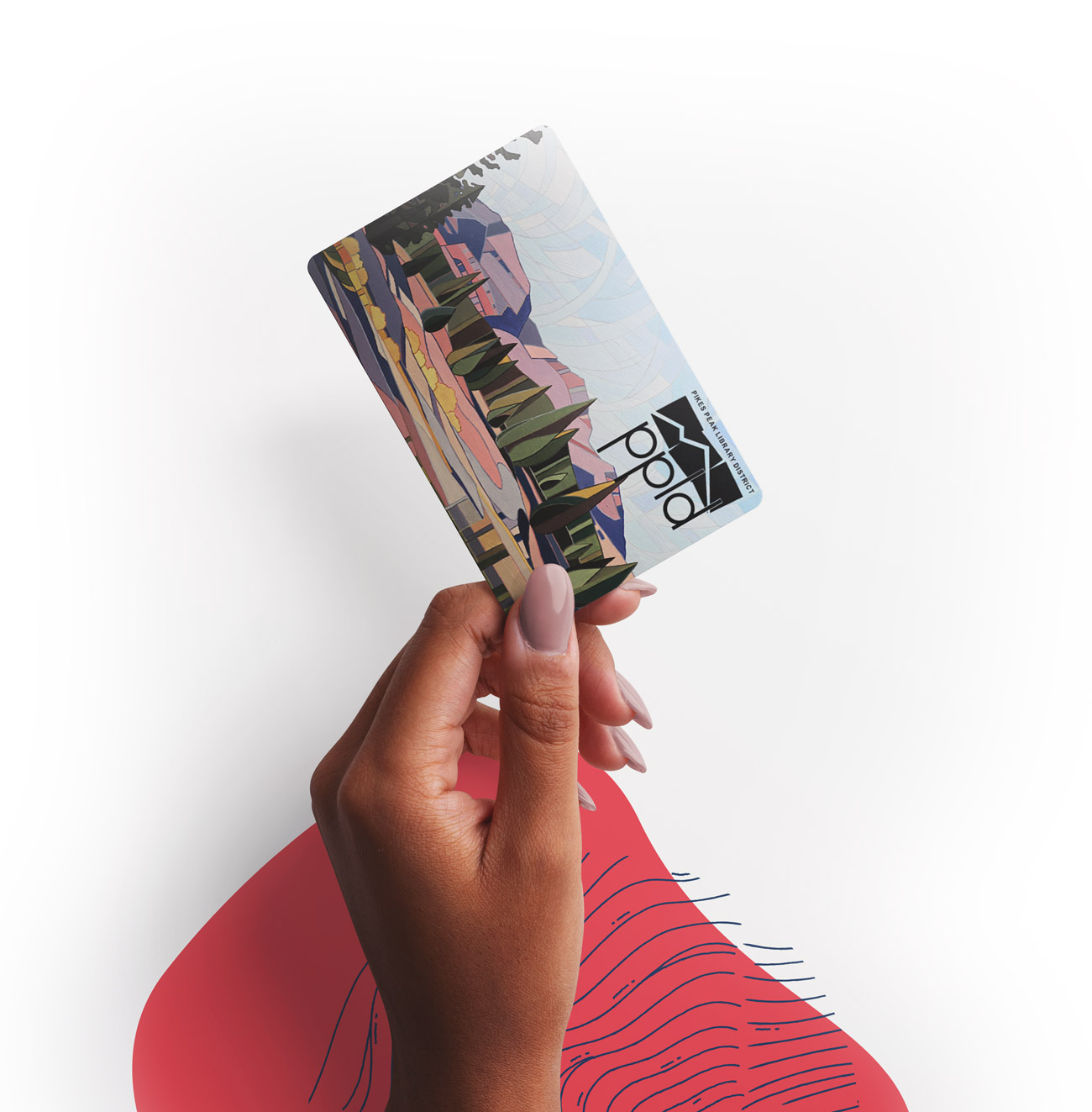 A person holding a Library card in their hand on a white table