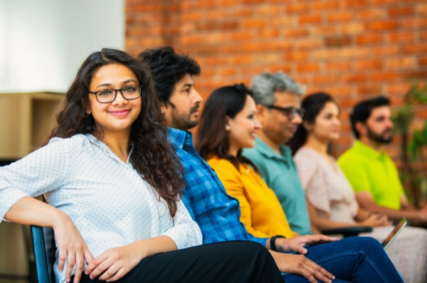 Young professionals gathered together in a classroom setting