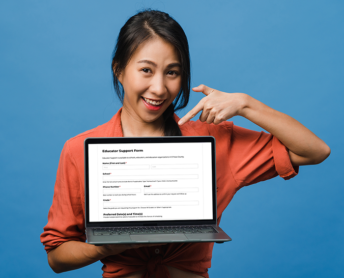 a woman pointing to a laptop screen with the Educator Support Form being displayed