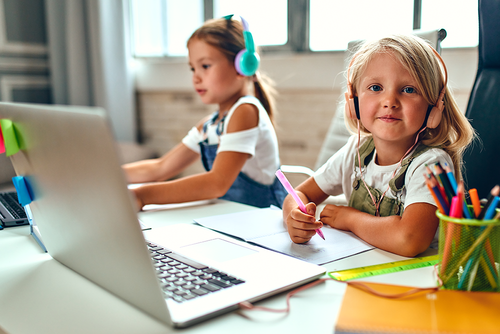 two young girls being tutored online