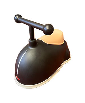 Child’s ride-on toy with a black whale design, tan seat, and T-shaped handlebar.