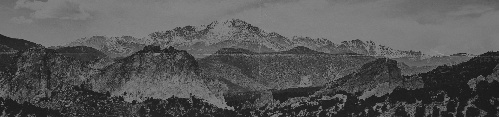 a black and white photo of Pikes Peak