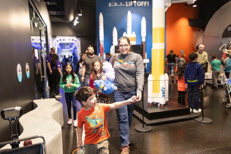 Photo of a family walking through exhibits in the Space Foundation