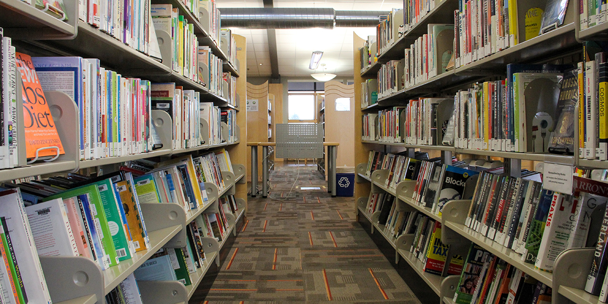 A photo between two book shelves in east library
