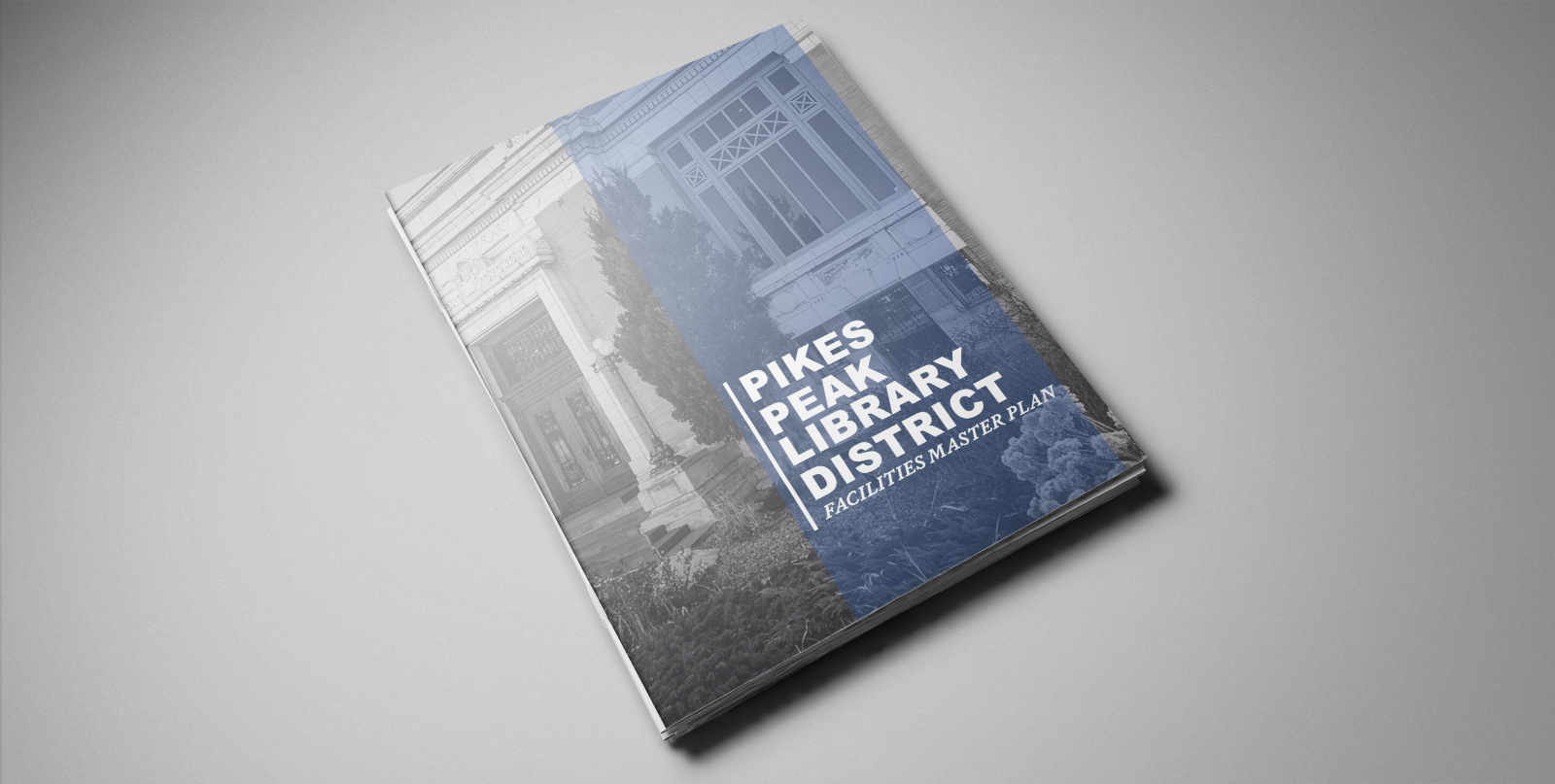 A photo of the Facilities Master Plan booklet sitting on a grey table