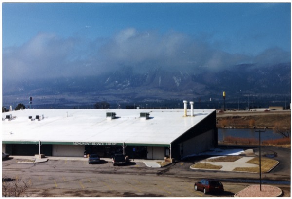 Monument Library pictured in front of the rocky mountains