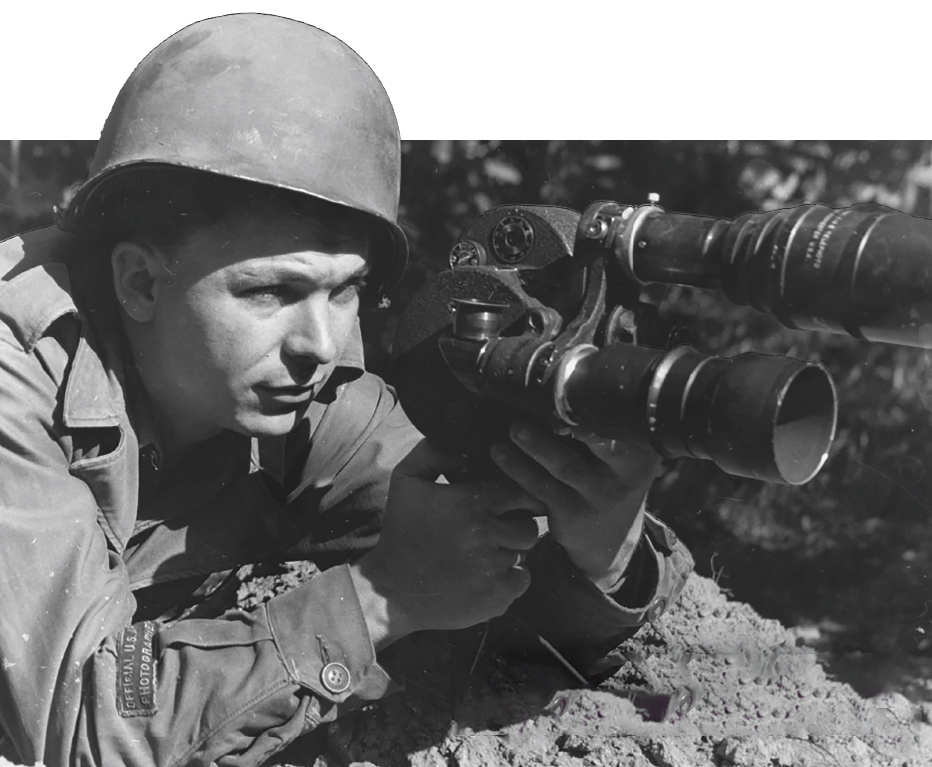 Jim Bates, ca. 1944, near the front line of the European theater with his Bell & Howell Eyemo 35mm camera, a mass-produced motion picture camera from the 1920s known for its compact, durable design.