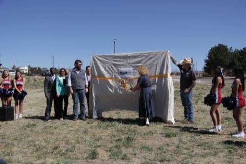 Teona Shainidze Krebs cutting the ribbon celebrating the purchase of Pony Tracks Property