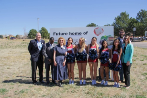 A group of people gathered around the sign that says "Future home of PPLD"