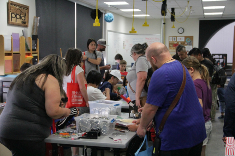 A group of people doing an activity at the East Library Open House