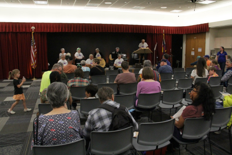 A Group of people watching a band play at the East library Open House