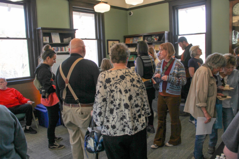People gathered around in a green room at the Manitou Springs Open House