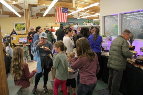 A group of people gathered in the Manitou Springs Library Open House Event