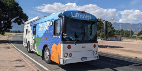 The Mobile Library Pictured on the road with Pikes Peak In the Background