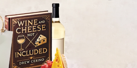 A book with the cover that says" Wine and Cheese note Included" also there is a Wine and cheese behind the book